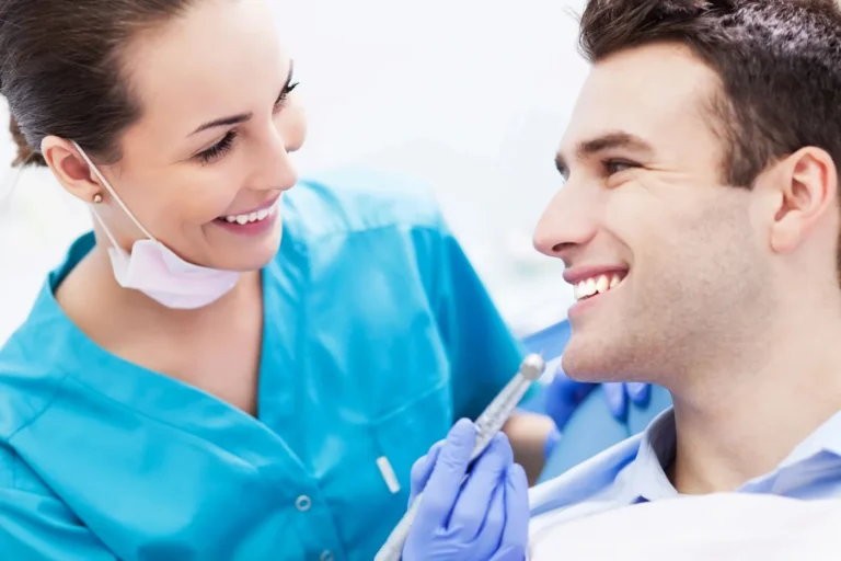 Dentist shaping tooth-coloured resin during a dental bonding treatment