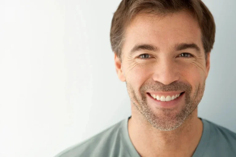Senior man smiling confidently with new dentures